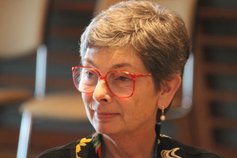 a close up of a person wearing red glasses